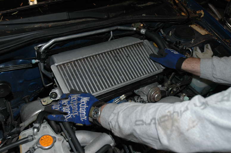 Carefully lift out the intercooler and the hoses should come free if you’ve loosened the clamps. 